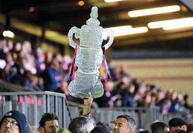 A foil replica FA Cup is held up high at Champion Hill in London to illustrate Degree apprenticeships: dont ruin something world is adopting